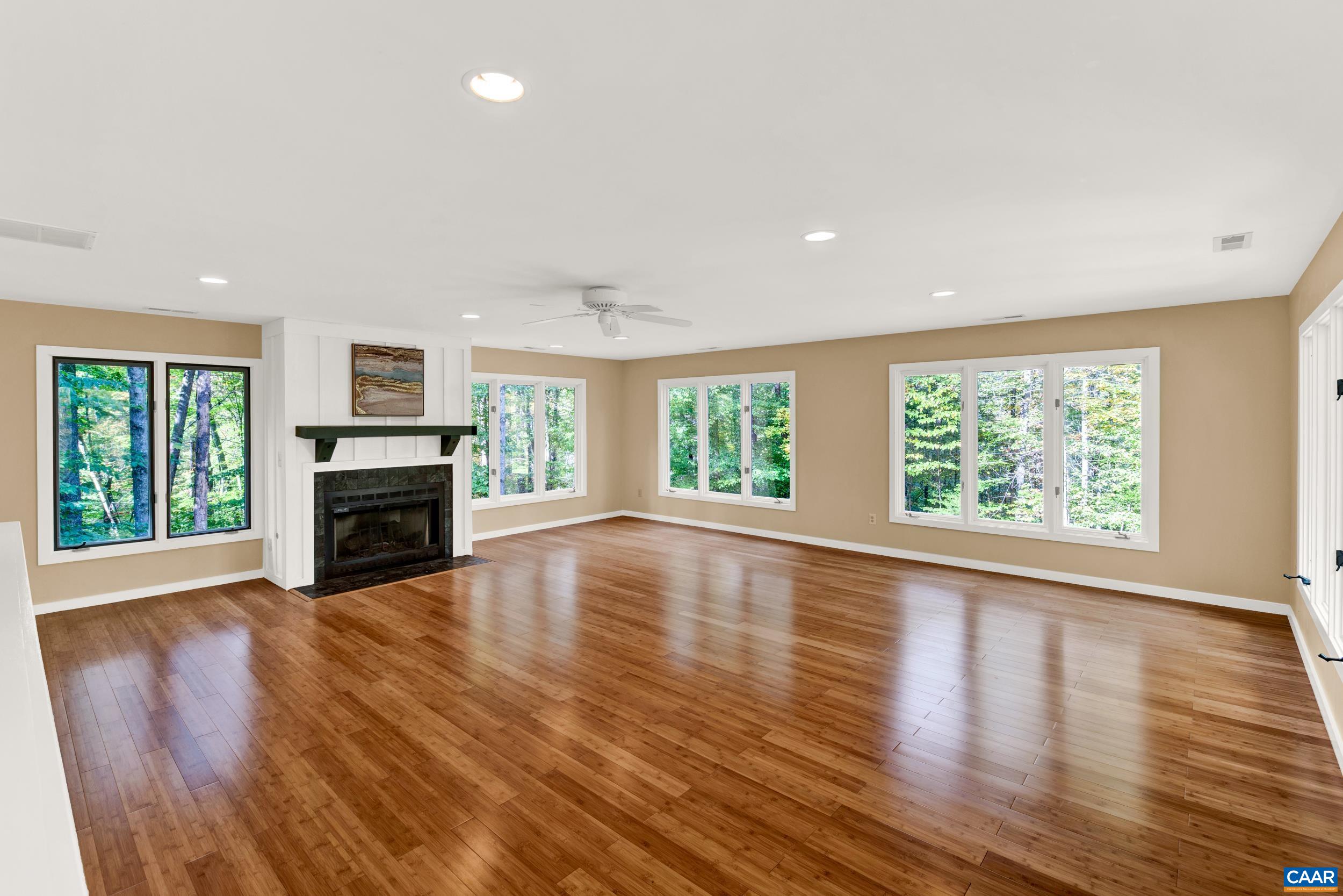 1065 Tilman Road Charlottesville, VA 22901 - Photo 32 of 70 wooden floor fireplace and windows in an empty room