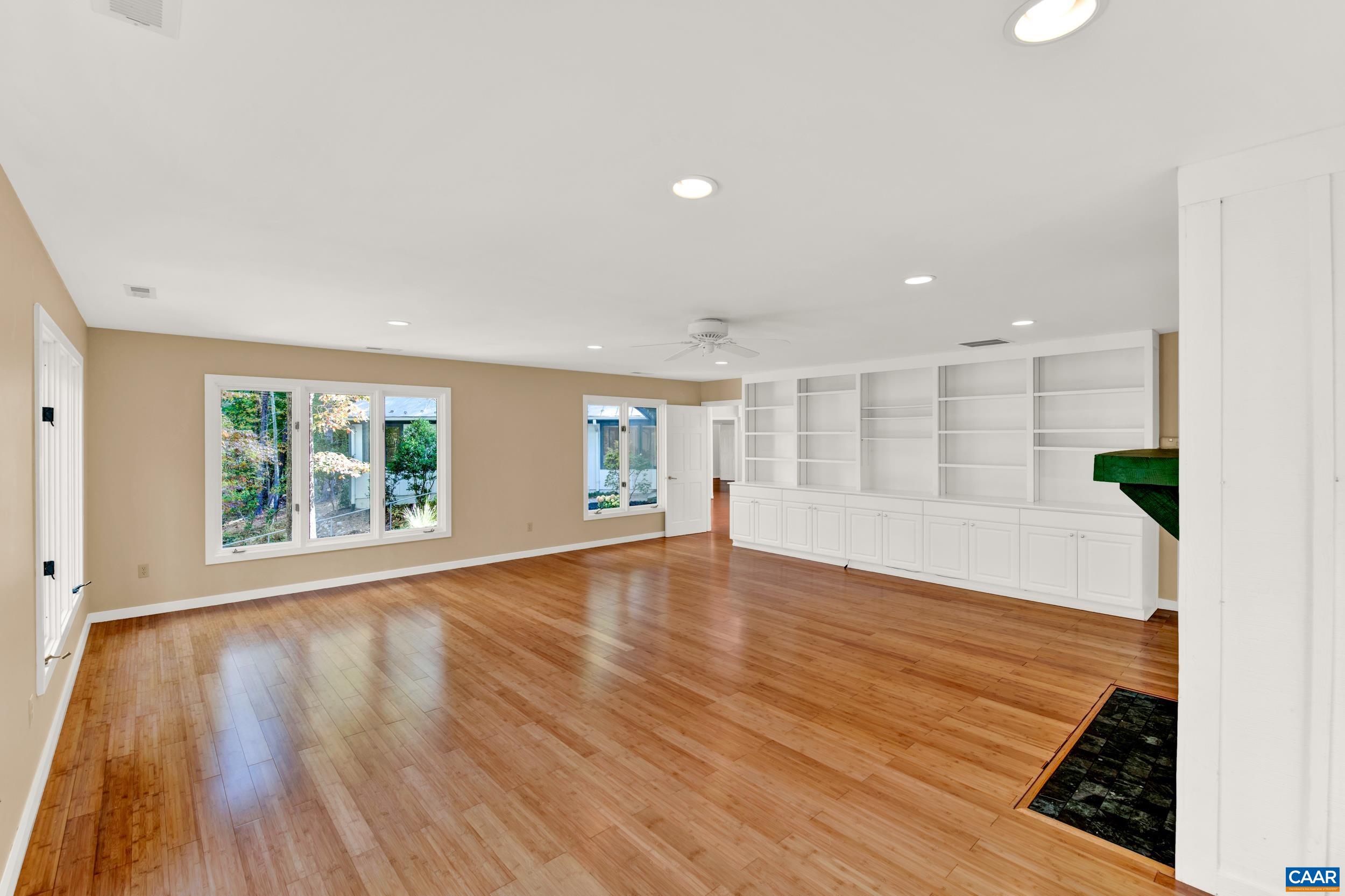 1065 Tilman Road Charlottesville, VA 22901 - Photo 34 of 70 an empty room with wooden floor and windows