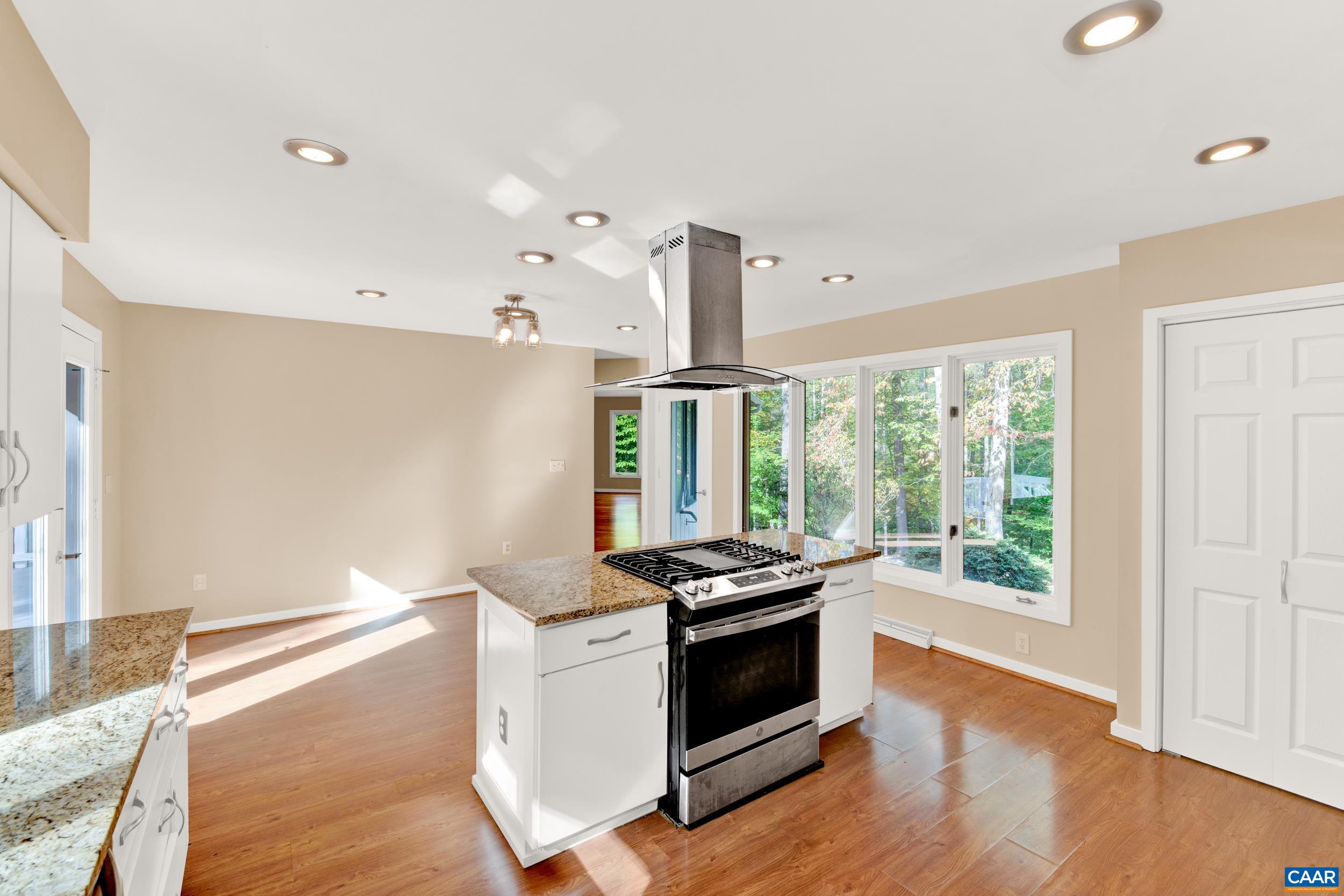 1065 Tilman Road Charlottesville, VA 22901 - Photo 40 of 70 a kitchen that has stainless steel appliances a stove and a wooden floor
