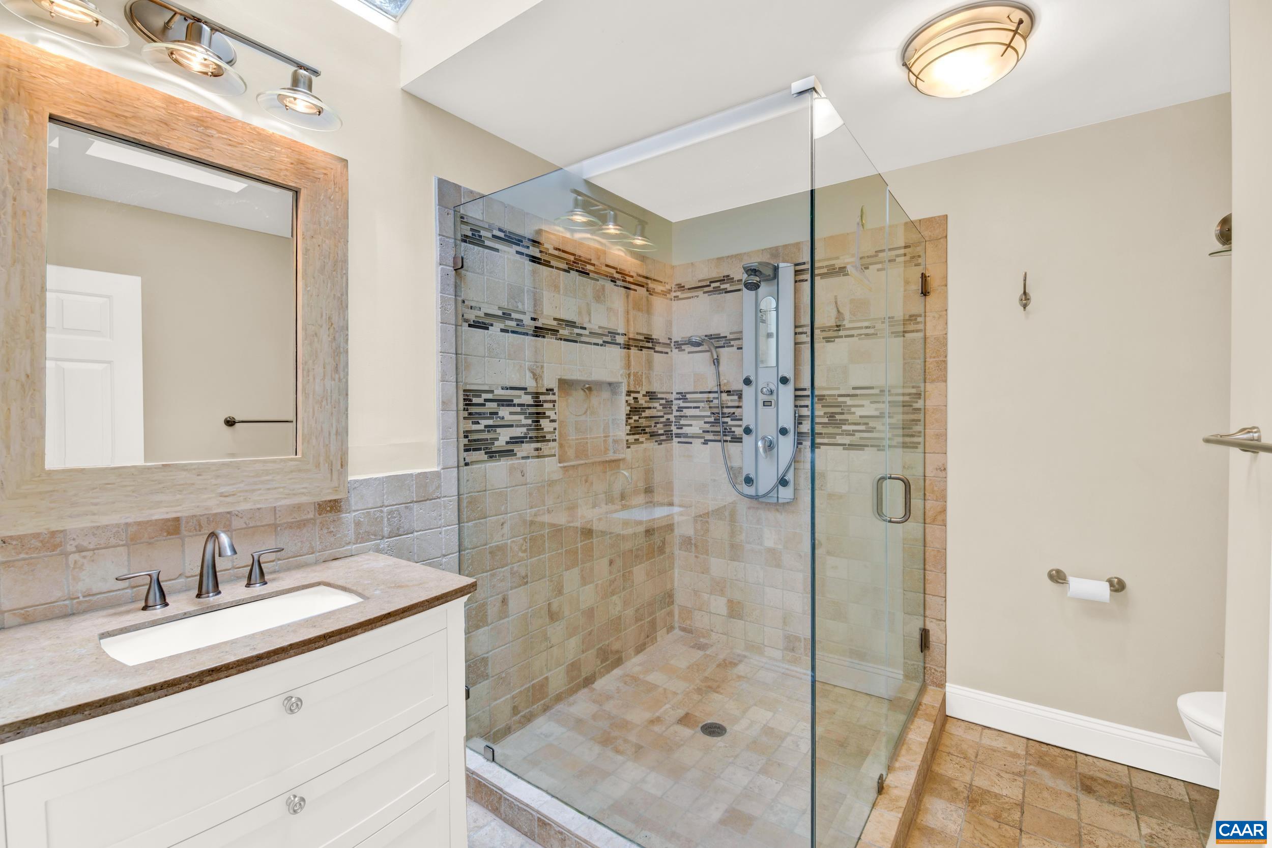 1065 Tilman Road Charlottesville, VA 22901 - Photo 55 of 70 a bathroom with a granite countertop sink mirror and shower