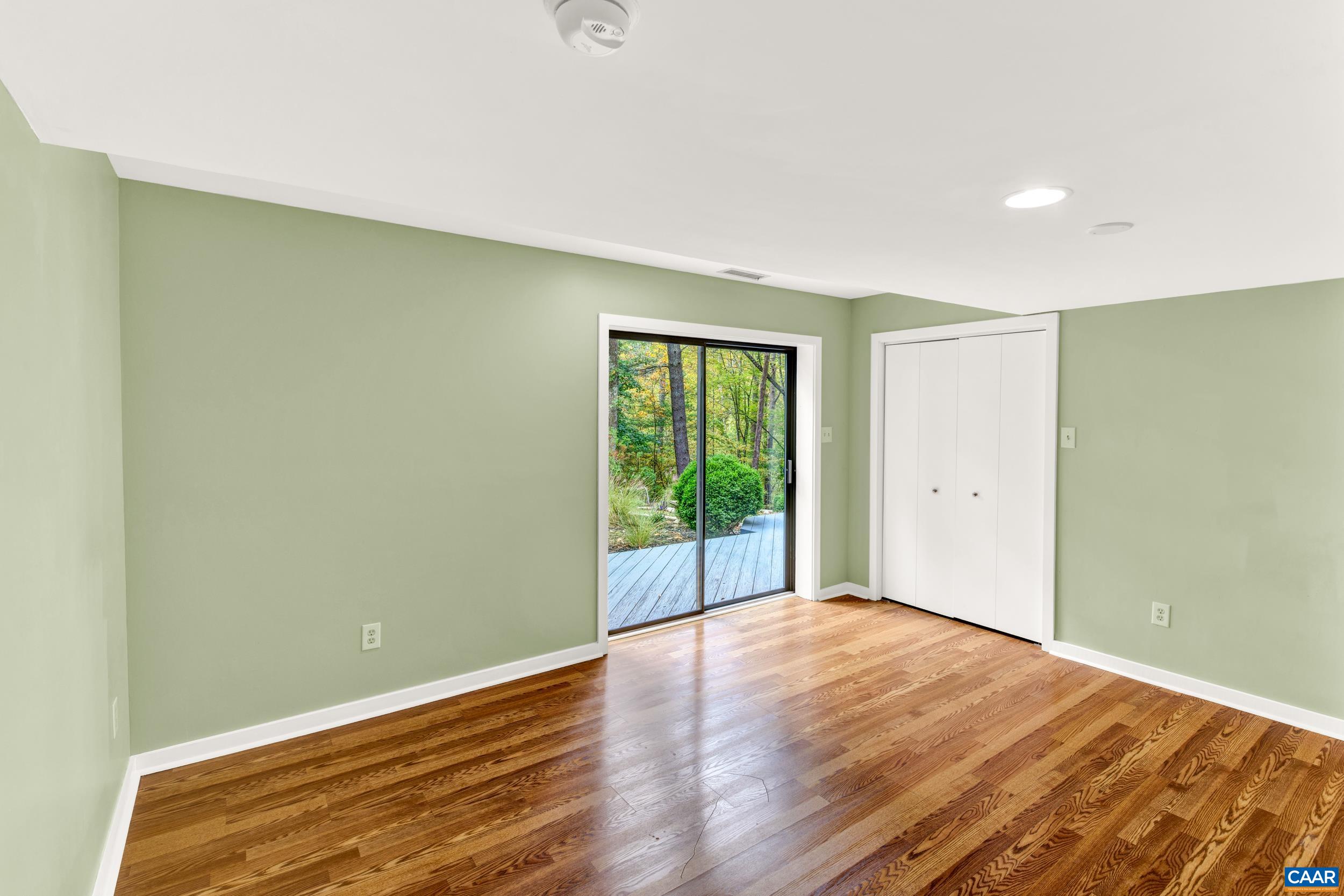 1065 Tilman Road Charlottesville, VA 22901 - Photo 59 of 70 a view of an empty room with wooden floor