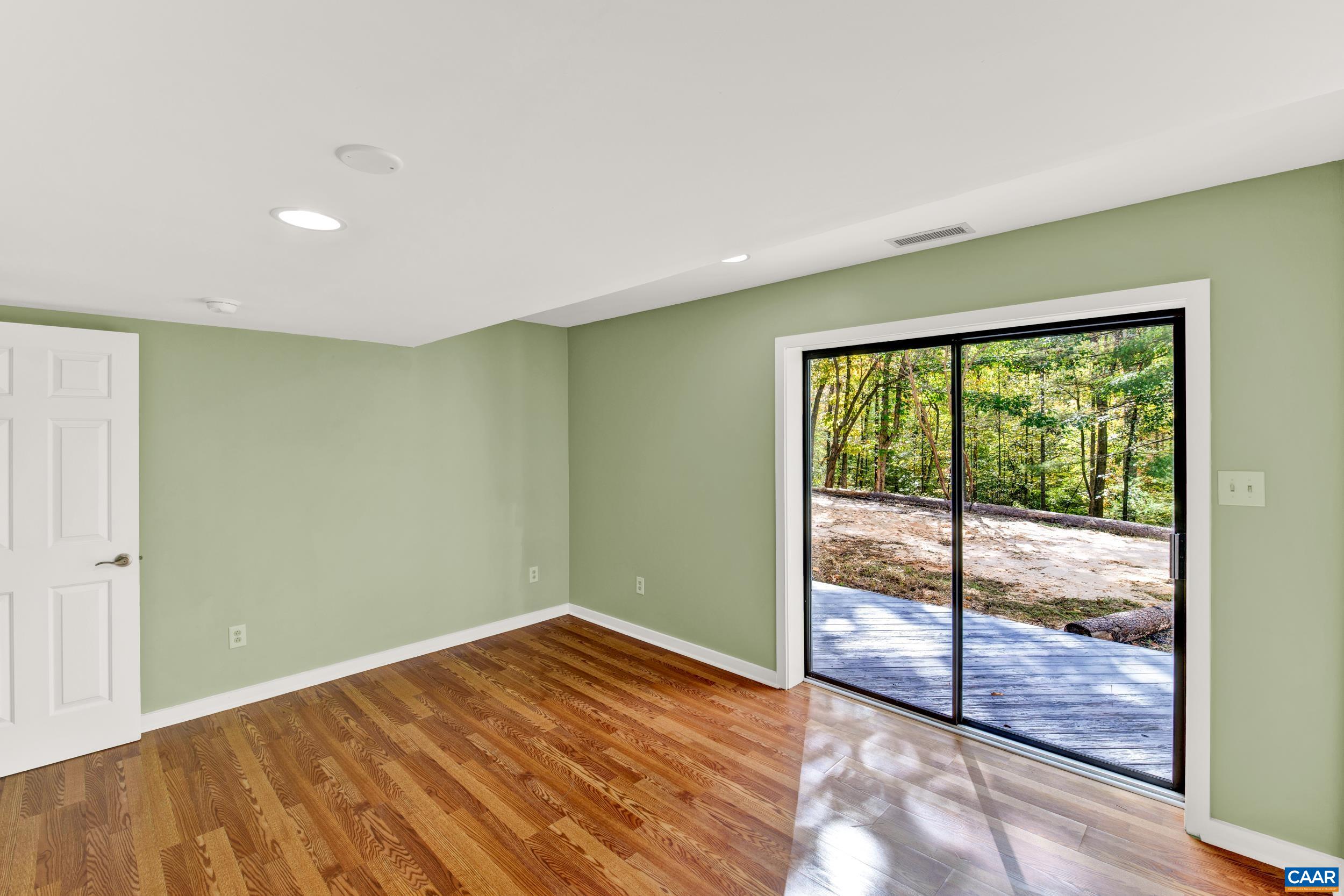 1065 Tilman Road Charlottesville, VA 22901 - Photo 61 of 70 a view of empty room with wooden floor and fan