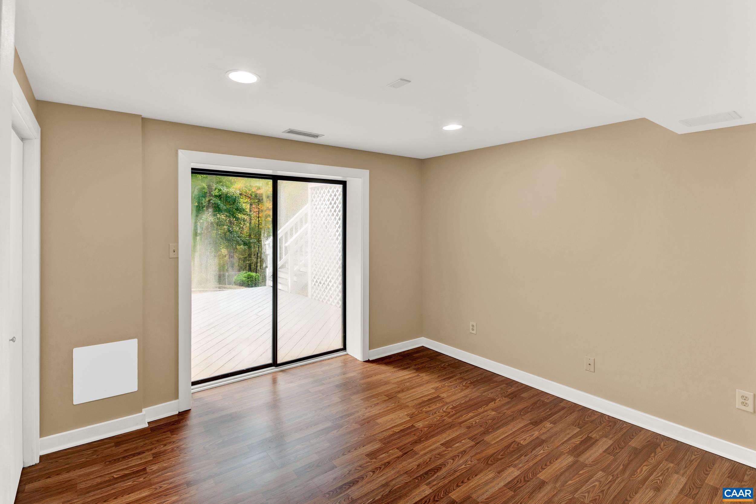 1065 Tilman Road Charlottesville, VA 22901 - Photo 64 of 70 a view of empty room with wooden floor and fan