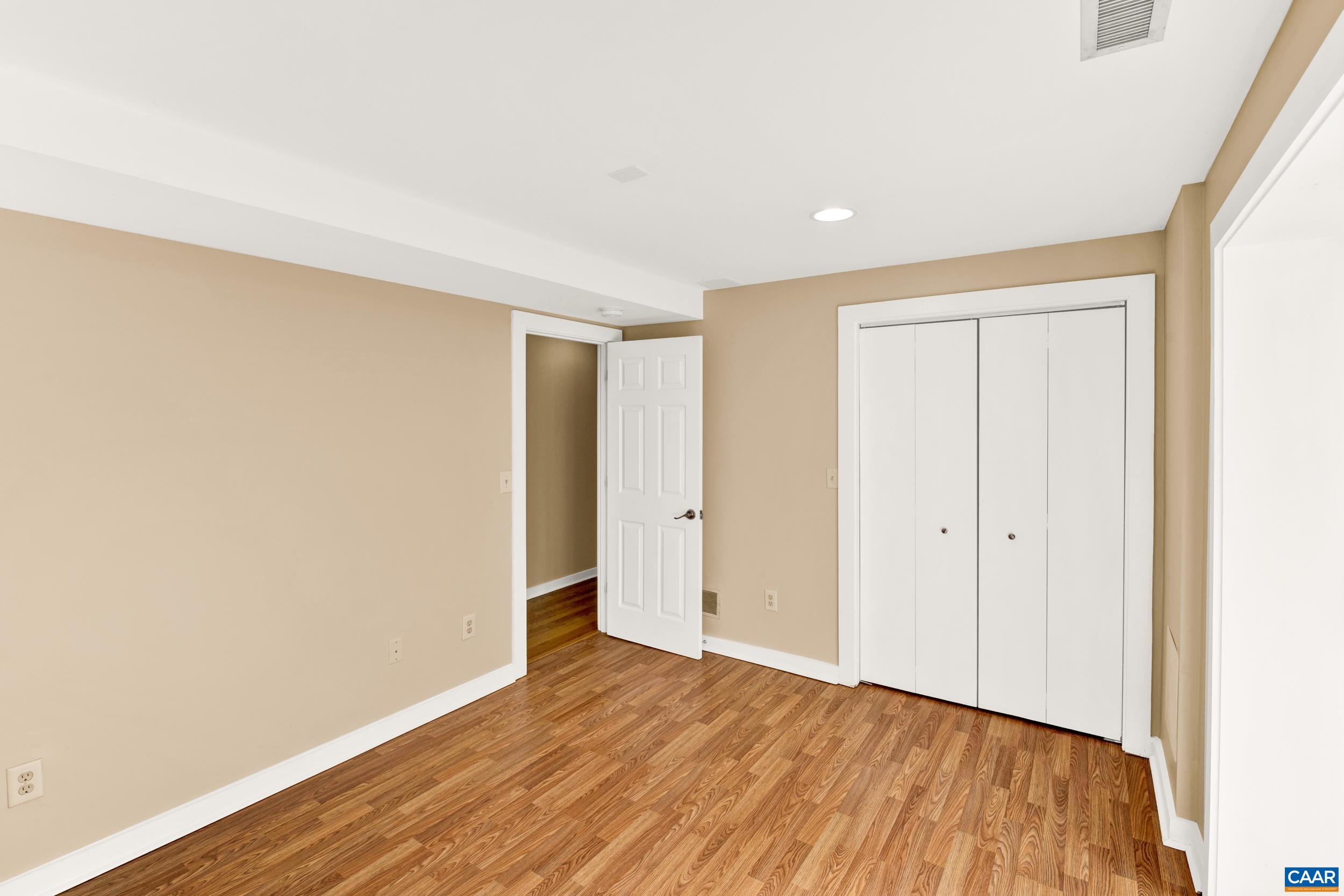 1065 Tilman Road Charlottesville, VA 22901 - Photo 65 of 70 a view of an empty room with wooden floor