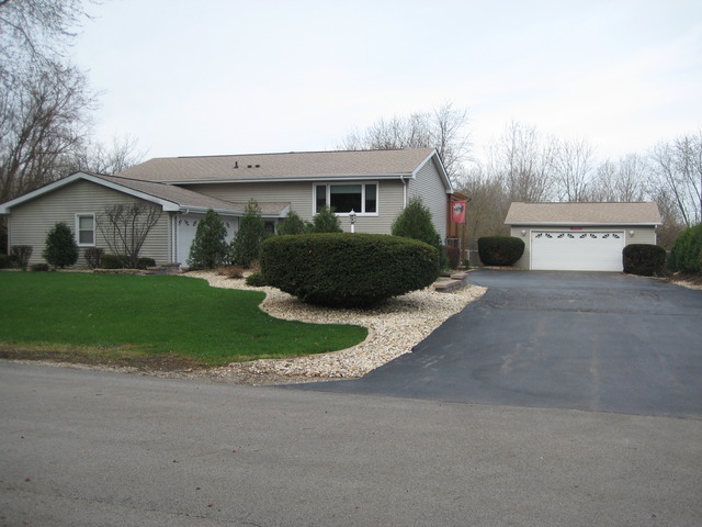 137 South Anderson Road New Lenox, IL 60451 - Photo 2 of 24 a front view of a house with a yard and garage