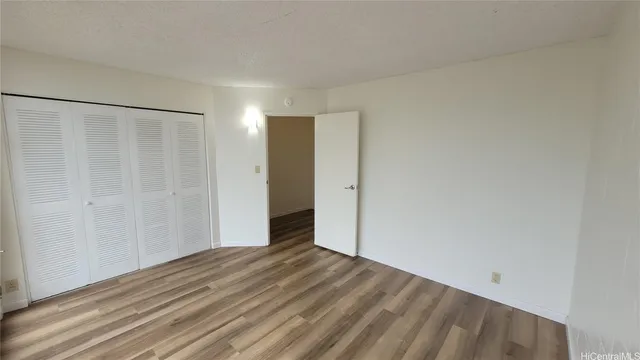 a view of a room with wooden floor