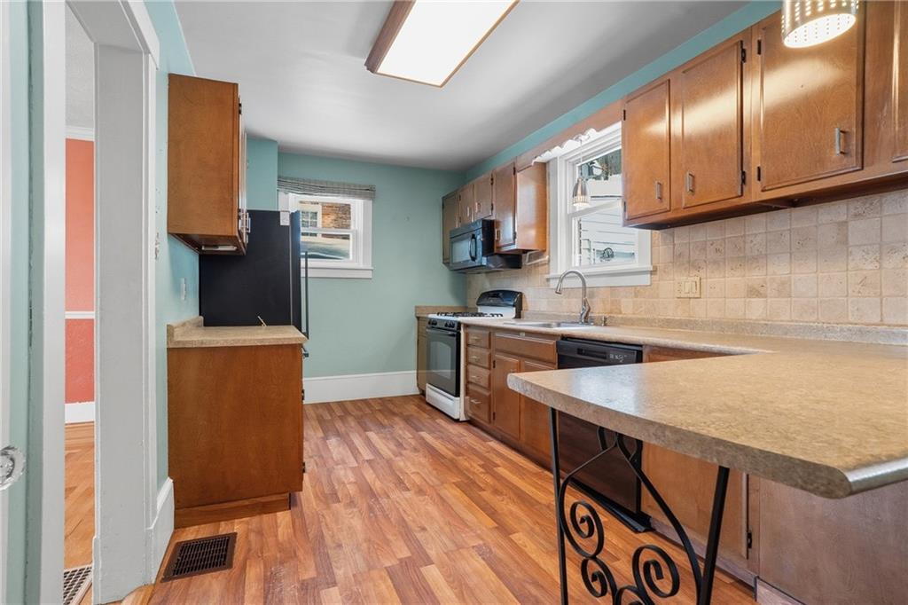 230 West Fulton Street Butler, PA 16001 - Photo 11 of 40 a kitchen with stainless steel appliances granite countertop a sink stove and refrigerator