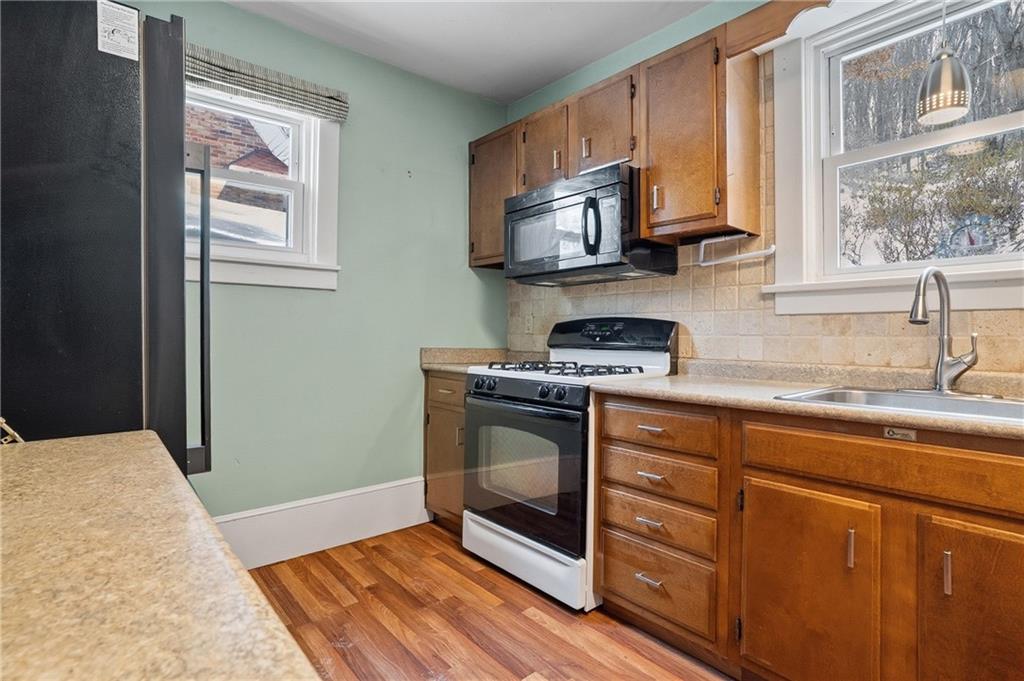 230 West Fulton Street Butler, PA 16001 - Photo 12 of 40 a kitchen with stainless steel appliances a stove microwave and sink