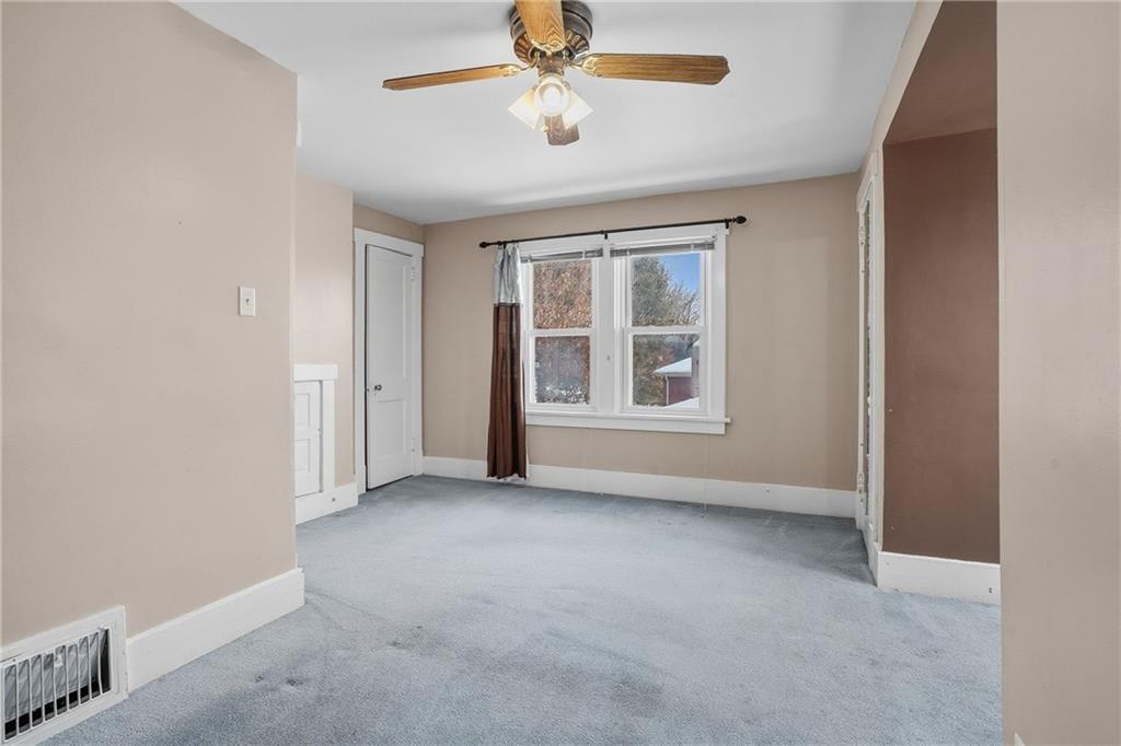 230 West Fulton Street Butler, PA 16001 - Photo 26 of 40 an empty room with chandelier fan and windows