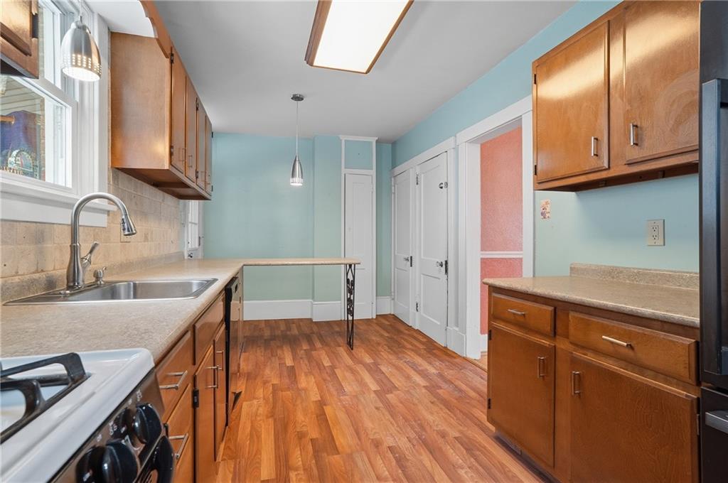 230 West Fulton Street Butler, PA 16001 - Photo 10 of 40 a kitchen with granite countertop wooden cabinets a sink and dishwasher