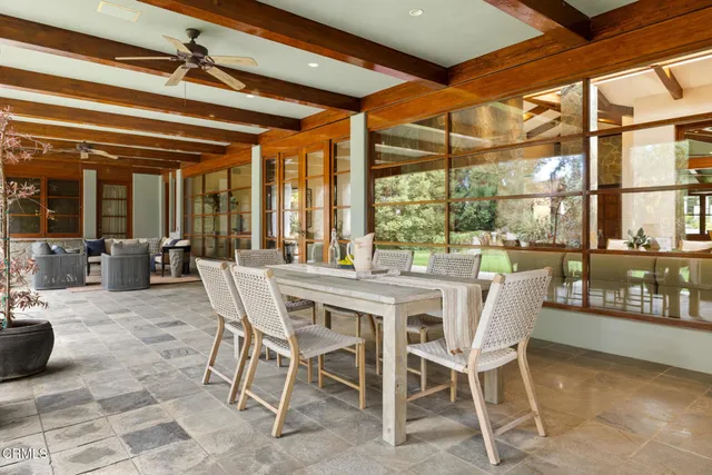a living room with furniture and floor to ceiling windows