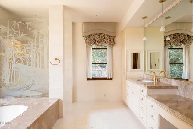 a bathroom with a tub and sink