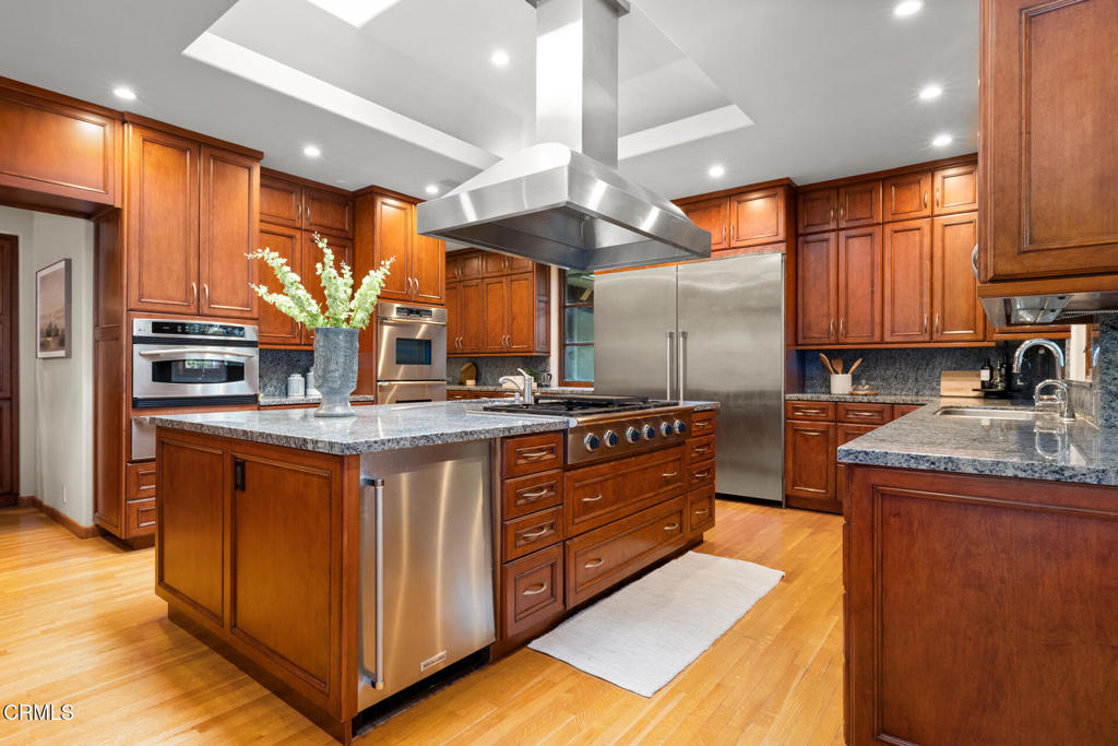 921 Chapea Road Pasadena, CA 91107 - Photo 7 of 22 a kitchen with stainless steel appliances granite countertop a sink a stove and a refrigerator