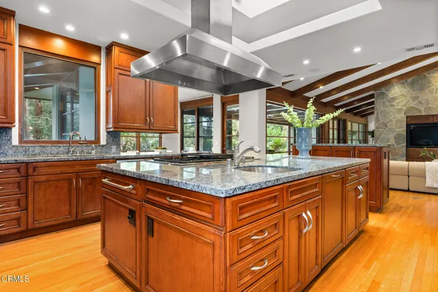 a dining room with furniture a chandelier and wooden floor