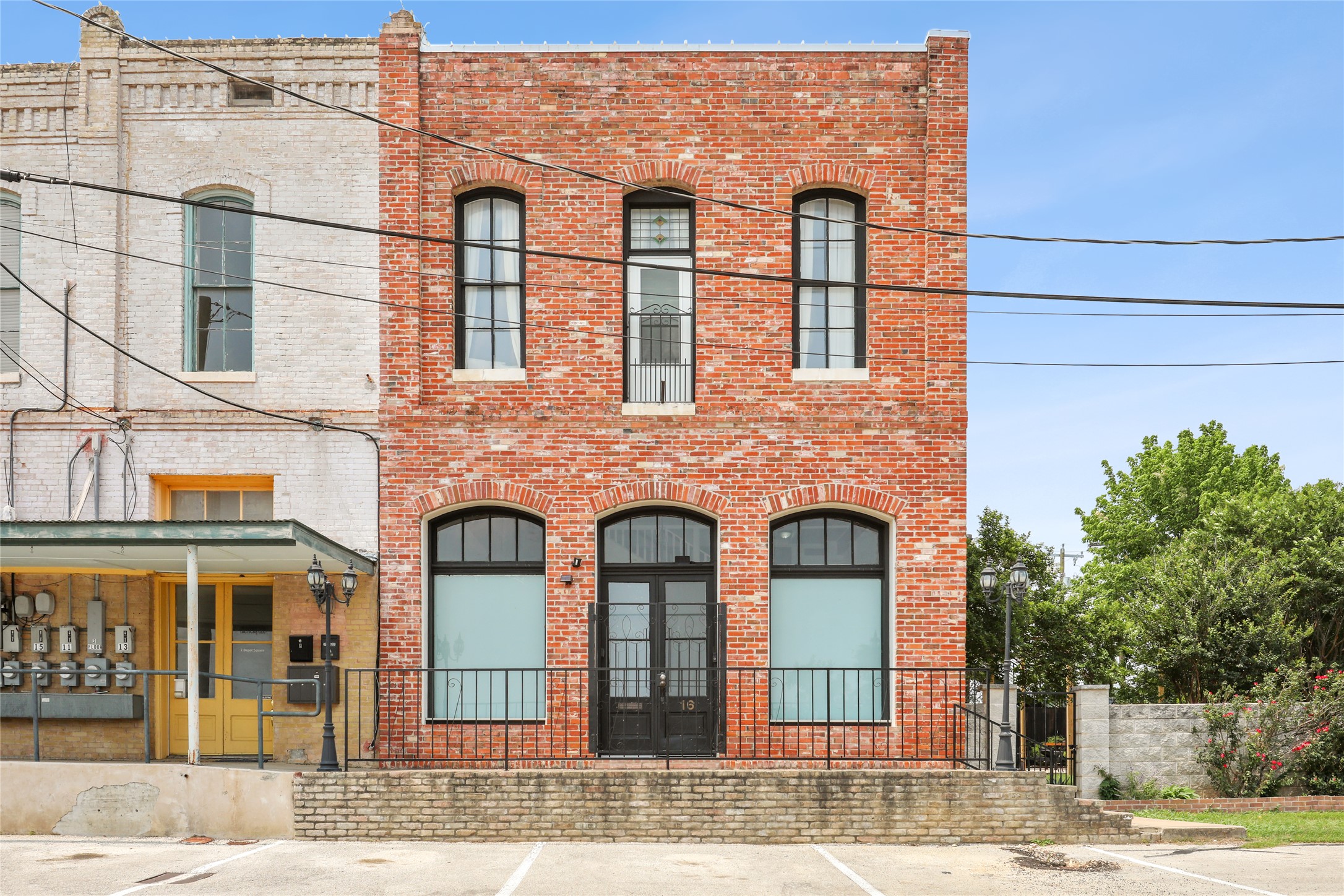 4 Depot Street Elgin, TX 78621 - Photo 1 of 1 Historic brick facade with arched windows and iron detailing defines this charming urban building.