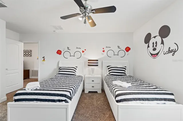 a bedroom with a bed and painting on the wall