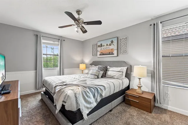 a bedroom with baby crib and a bed