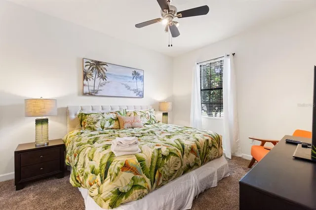 a bedroom with bed and wooden floor