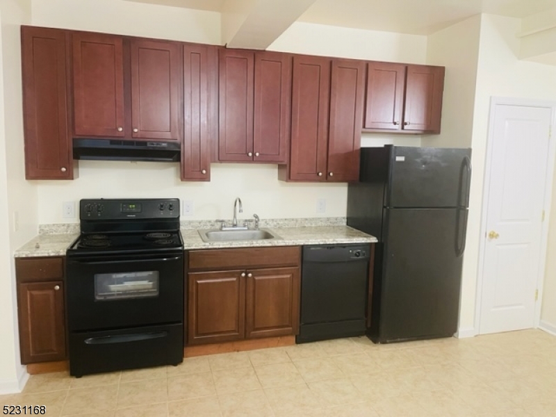 a kitchen with a refrigerator stove and cabinets