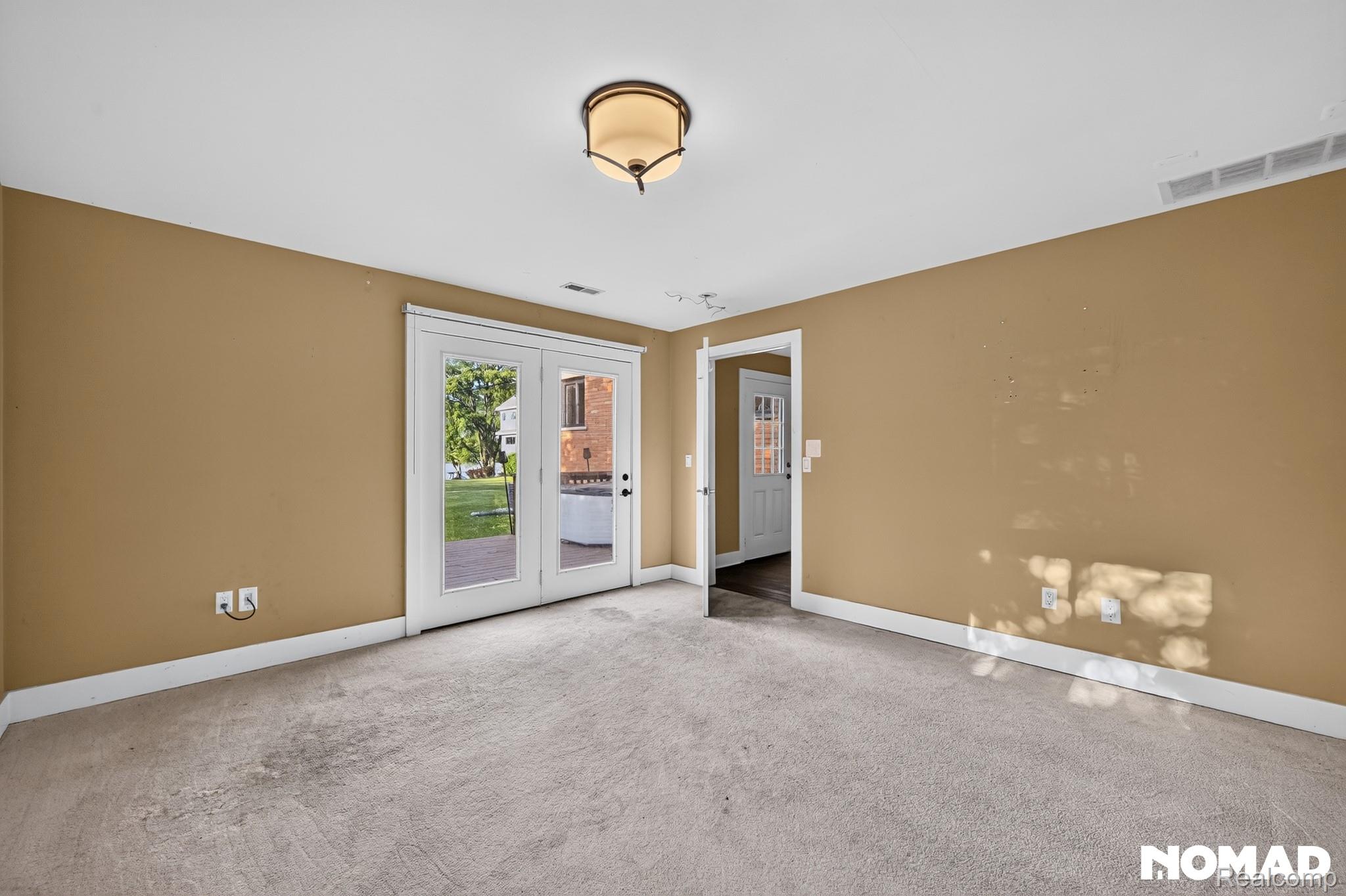 8315 Hilton Road Brighton, MI 48114 - Photo 9 of 26 Carpeted room featuring a white baseboard, a ceiling light fixture, and a white door frame