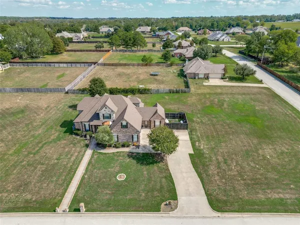 an aerial view of residential houses with outdoor space and swimming pool