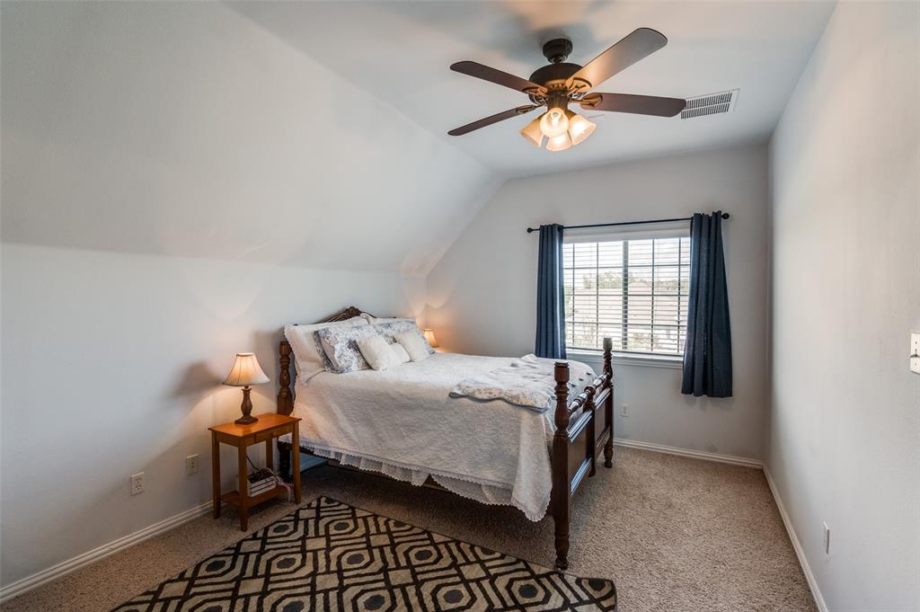 336 Maggie Street Canton, TX 75103 - Photo 21 of 30 a bedroom with a bed and a ceiling fan