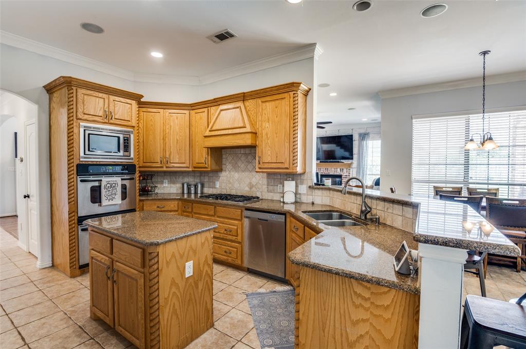 336 Maggie Street Canton, TX 75103 - Photo 5 of 30 a kitchen with stainless steel appliances granite countertop a sink stove and refrigerator