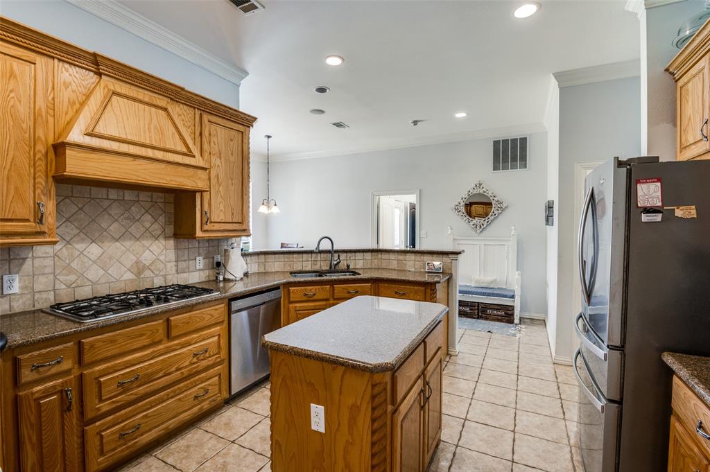 336 Maggie Street Canton, TX 75103 - Photo 6 of 30 a kitchen with stainless steel appliances granite countertop a sink stove and refrigerator