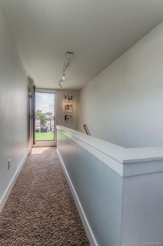 a big room with wooden floor and windows