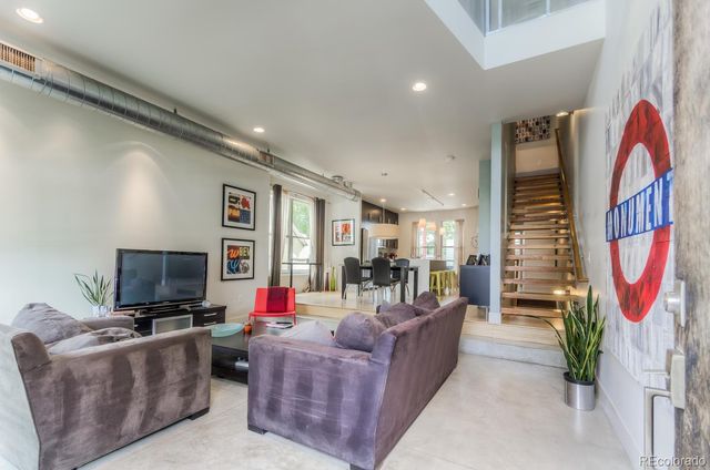 a living room with furniture fireplace and flat screen tv