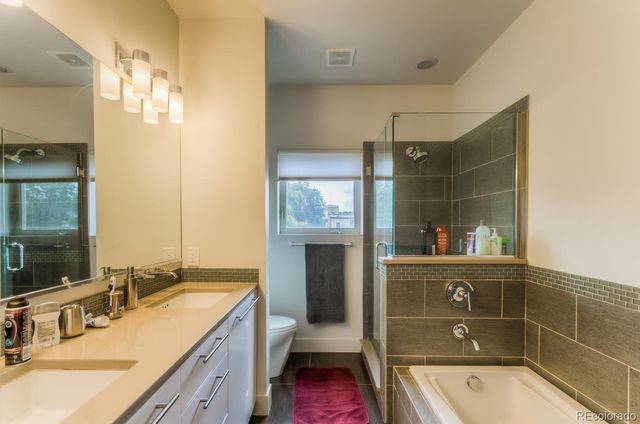 a bathroom with a tub sink and mirror