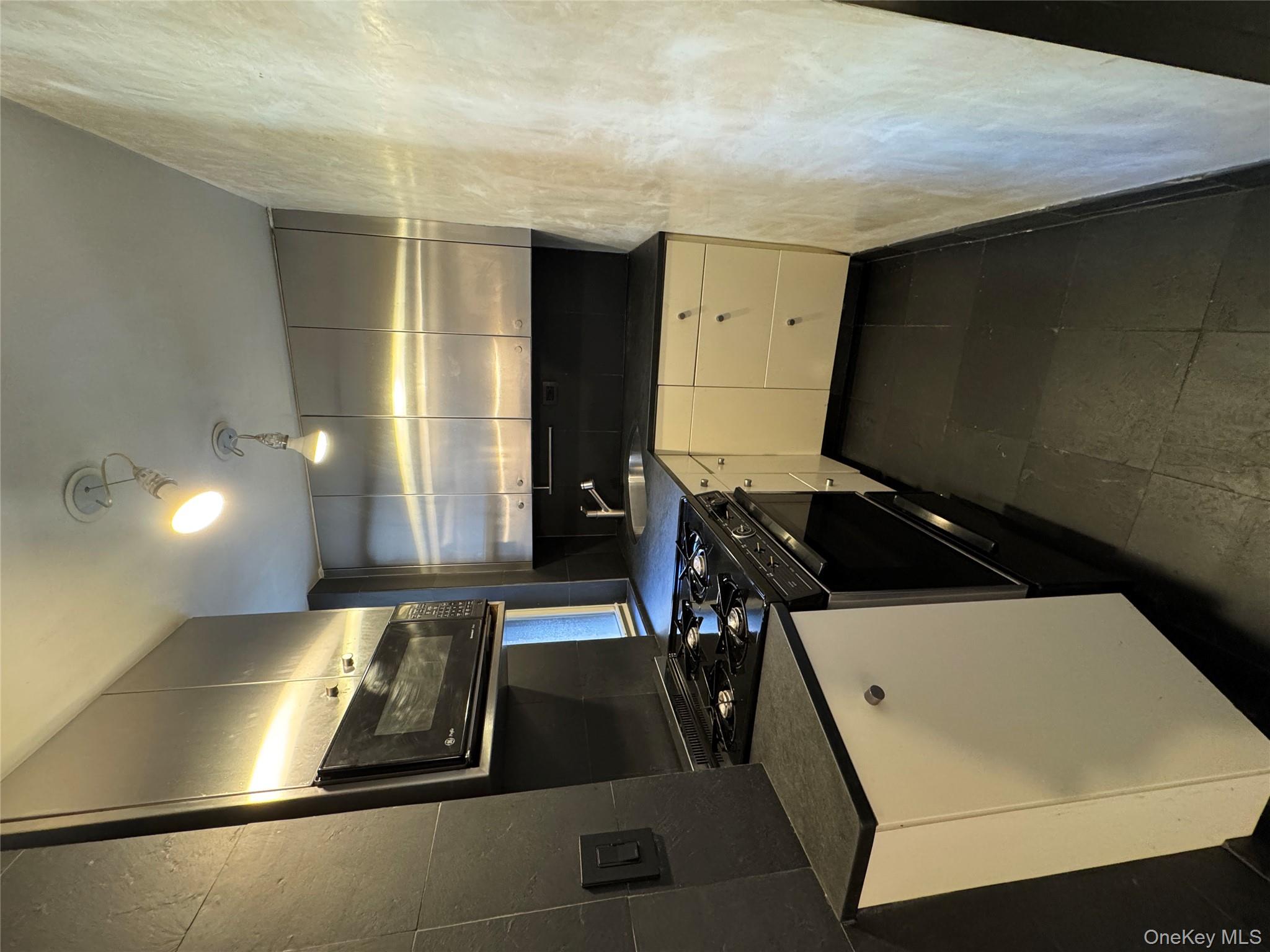 333 East 53rd Street, Unit 5C Manhattan, NY 10022 - Photo 12 of 27 a kitchen with a stove and a sink