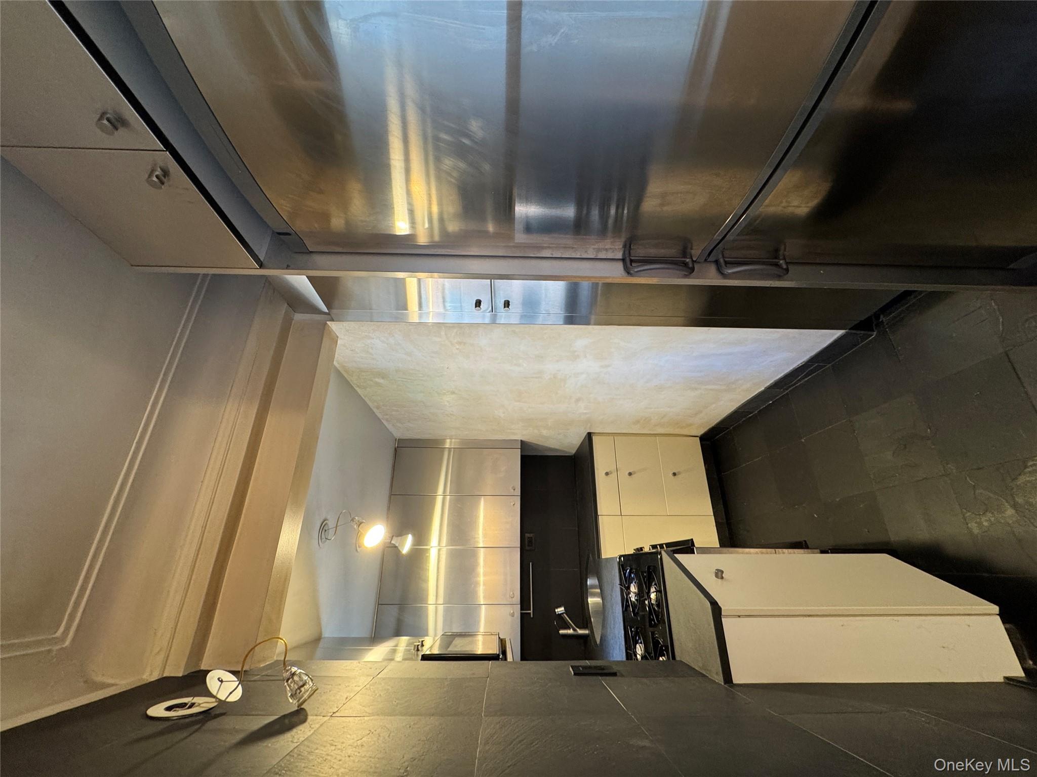 333 East 53rd Street, Unit 5C Manhattan, NY 10022 - Photo 13 of 27 a kitchen with a refrigerator and white cabinets