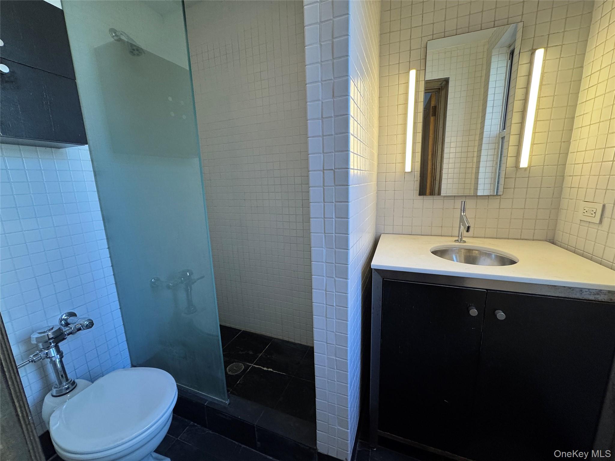 333 East 53rd Street, Unit 5C Manhattan, NY 10022 - Photo 14 of 27 a bathroom with a sink and a mirror