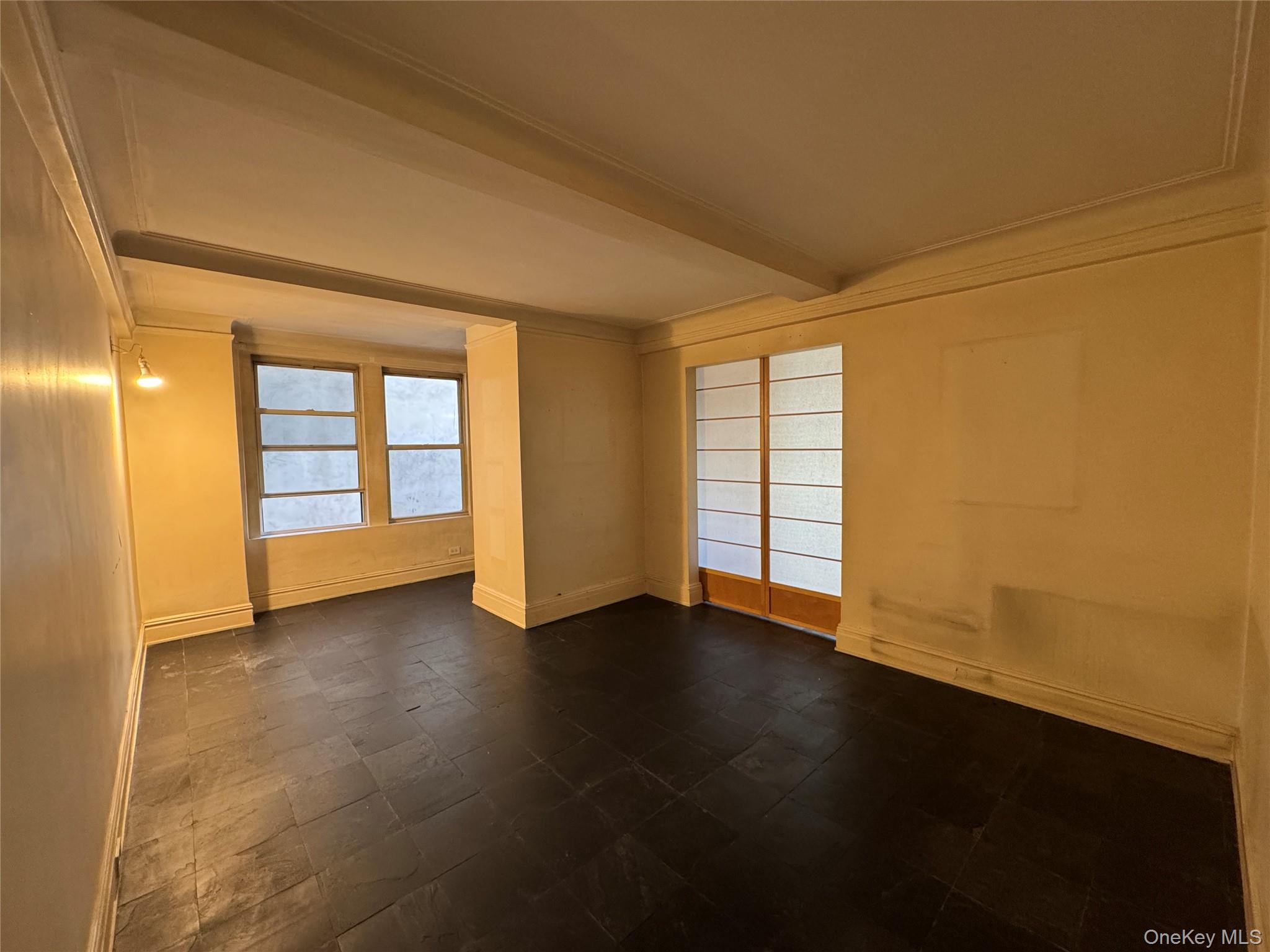 333 East 53rd Street, Unit 5C Manhattan, NY 10022 - Photo 23 of 27 an empty room with wooden floor and windows