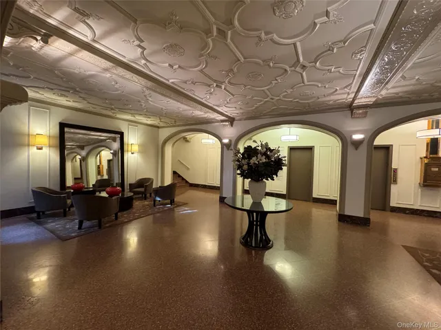 a living room with lots of furniture and a chandelier