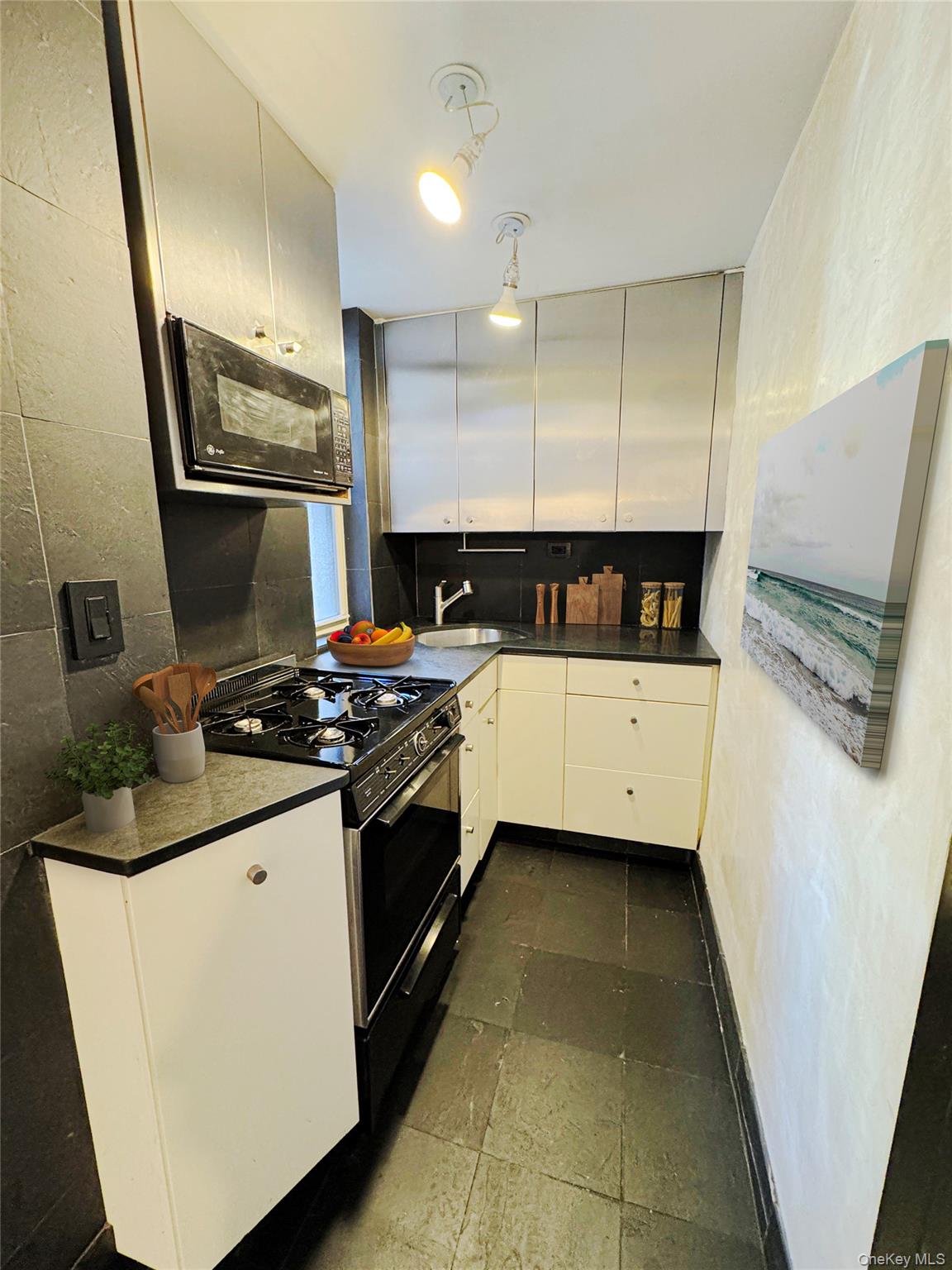 333 East 53rd Street, Unit 5C Manhattan, NY 10022 - Photo 8 of 27 a kitchen with a stove and a sink