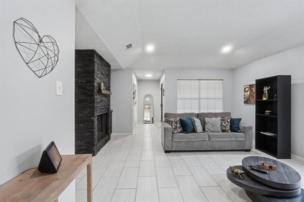 9780 Windy Ridge Road Frisco, TX 75033 - Photo 5 of 25 Spacious living area featuring light-toned tile flooring throughout and recessed lighting