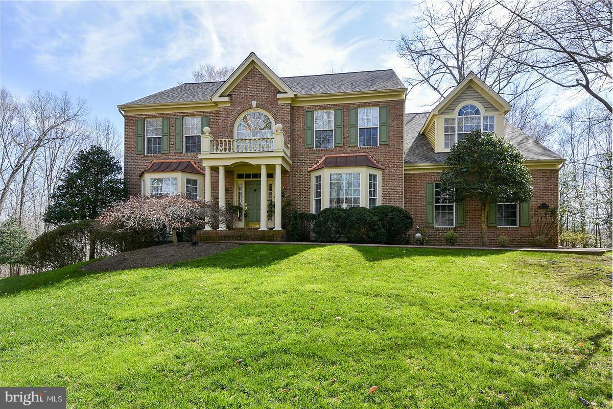 10839 Moore Drive Manassas, VA 20111 - Photo 1 of 30 a front view of a house with yard and green space