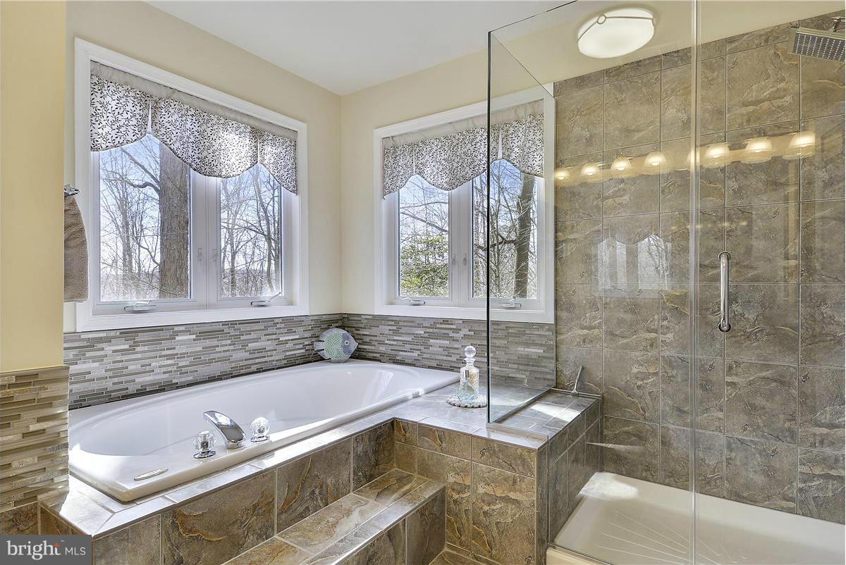 10839 Moore Drive Manassas, VA 20111 - Photo 17 of 30 a bathroom with a tub sink and glass door