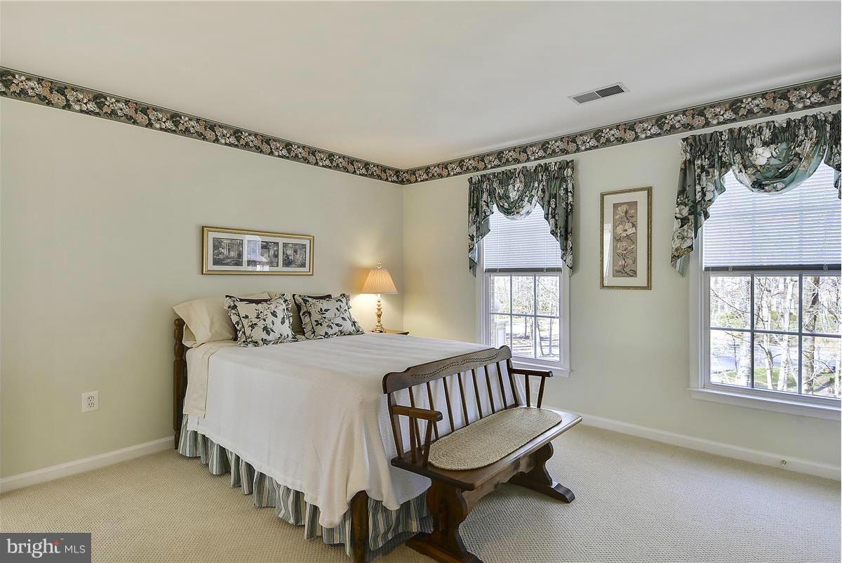 10839 Moore Drive Manassas, VA 20111 - Photo 20 of 30 a bedroom with a bed window and a table in it