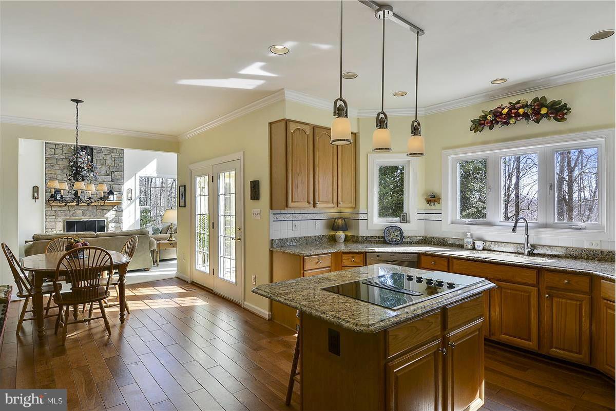 10839 Moore Drive Manassas, VA 20111 - Photo 4 of 30 a kitchen that has a sink a table and chairs in it