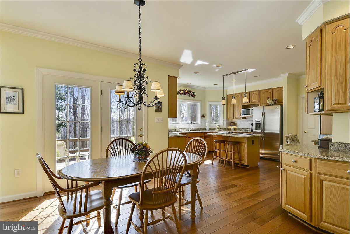 10839 Moore Drive Manassas, VA 20111 - Photo 6 of 30 a dining room filled chandelier and wooden floor