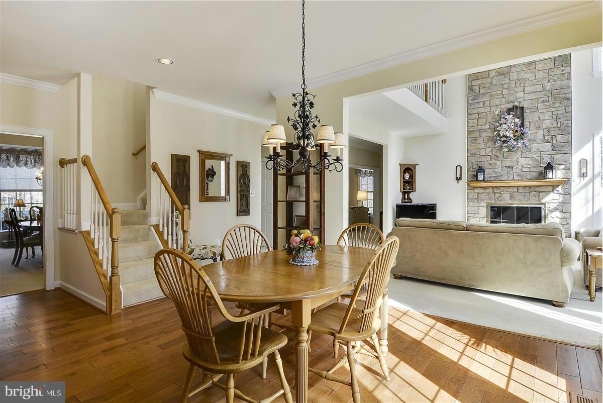 10839 Moore Drive Manassas, VA 20111 - Photo 7 of 30 a view of a dining room with furniture wooden floor and chandelier