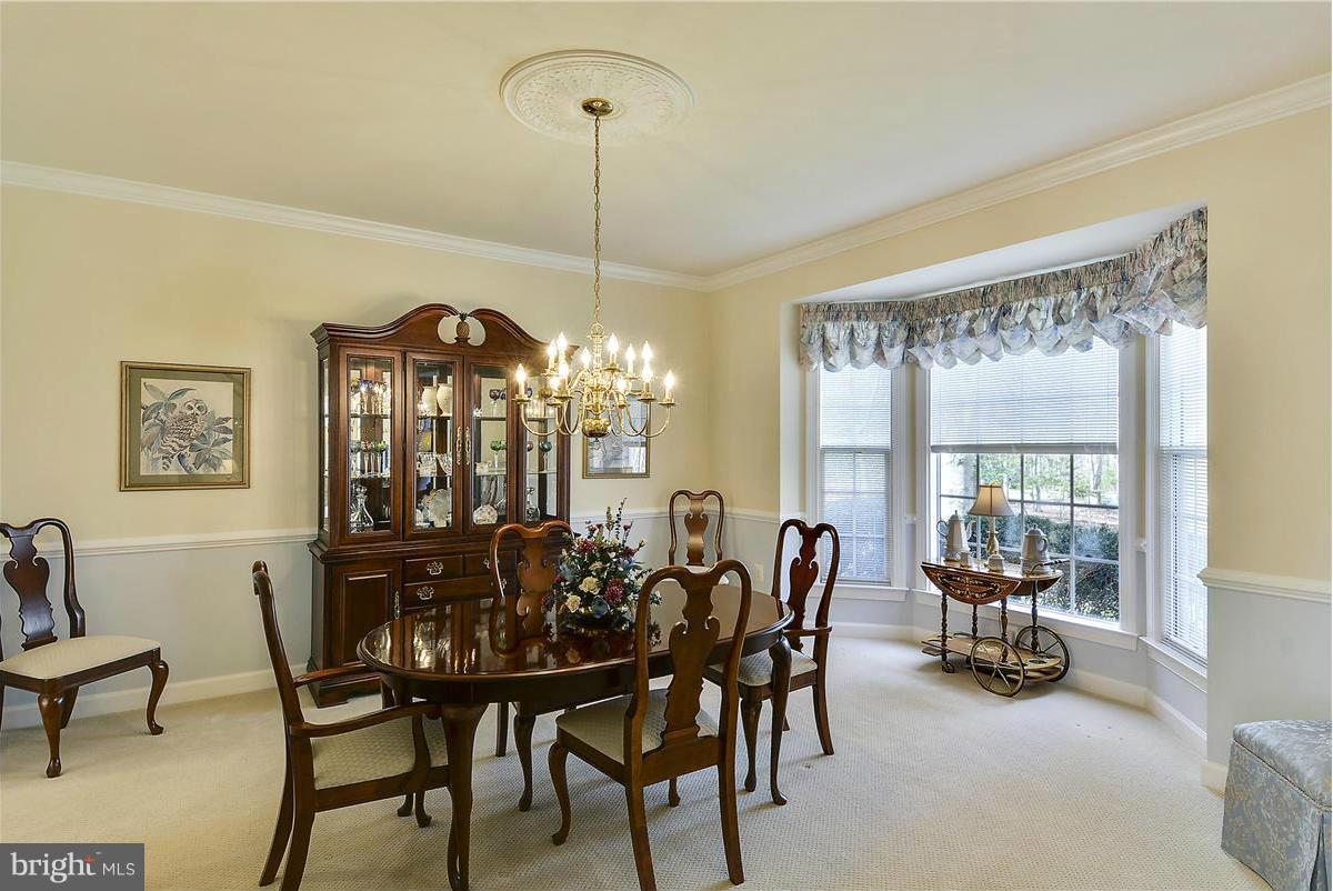 10839 Moore Drive Manassas, VA 20111 - Photo 9 of 30 a view of a dining room with furniture wooden floor and chandelier