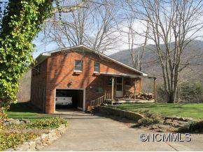 158 Howell Cove Road Canton, NC 28716 - Photo 1 of 14 a front view of a house with a yard