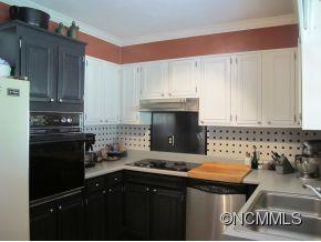 158 Howell Cove Road Canton, NC 28716 - Photo 4 of 14 a kitchen with a sink and a stove top oven
