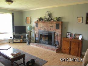 158 Howell Cove Road Canton, NC 28716 - Photo 8 of 14 a living room with furniture and a fireplace