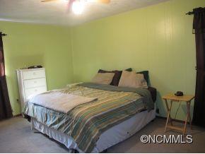 158 Howell Cove Road Canton, NC 28716 - Photo 10 of 14 a bedroom with a bed and window