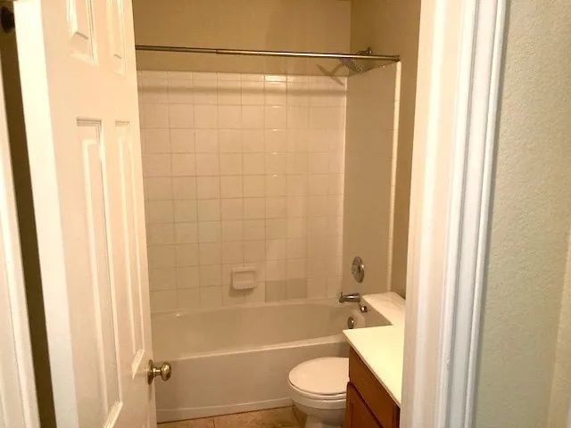 a bathroom with a shower a toilet and a shower